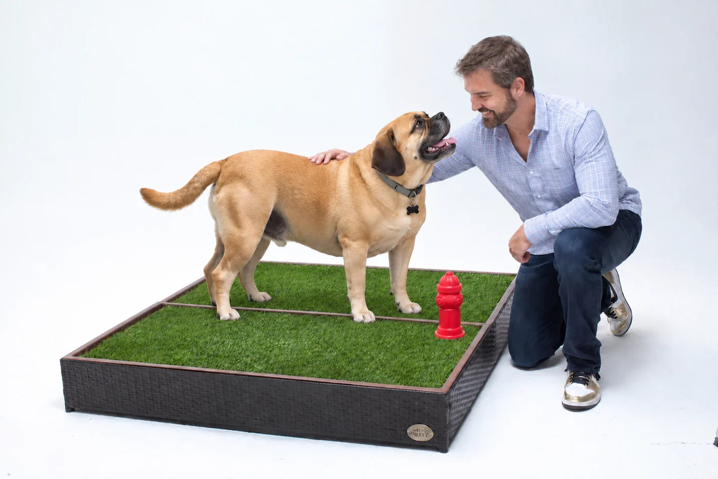 Porch Potty founder Brandon Kennington with his dog standing on a CLASSIC Mega
