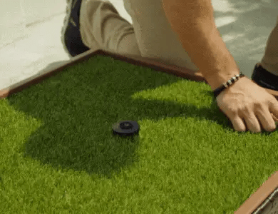 Grass surface being placed into a Porch Potty