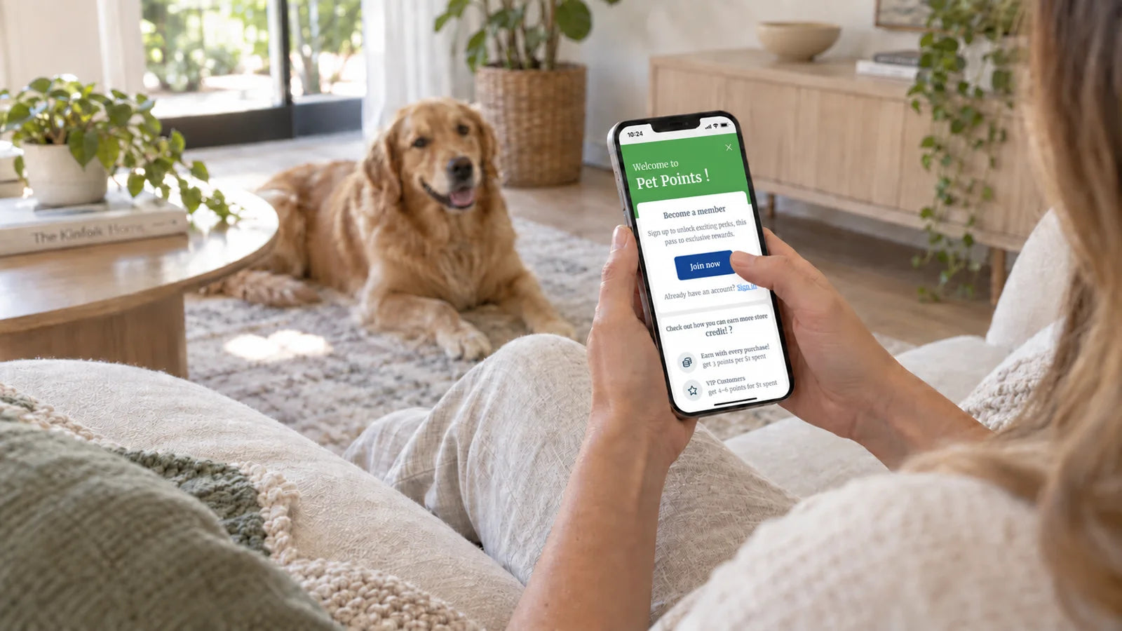 A dog owner exploring Porch Potty Pet Points on her phone with her golden retriever nearby