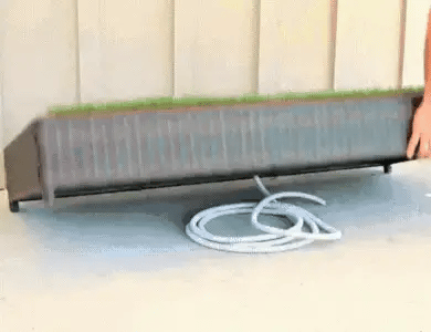 Porch Potty drain hose beneath the grass platform