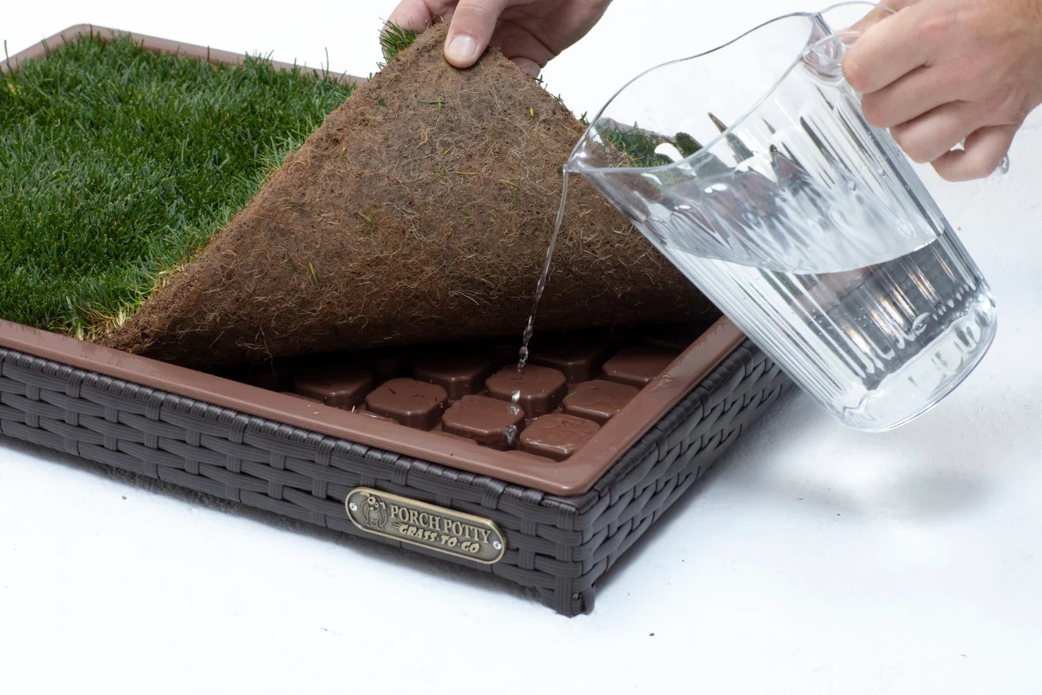 Watering the real sod tray in a Porch Potty CLASSIC Mini dog potty